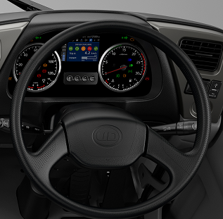 Black steering wheel with dashboard showing gauges and indicator lights.