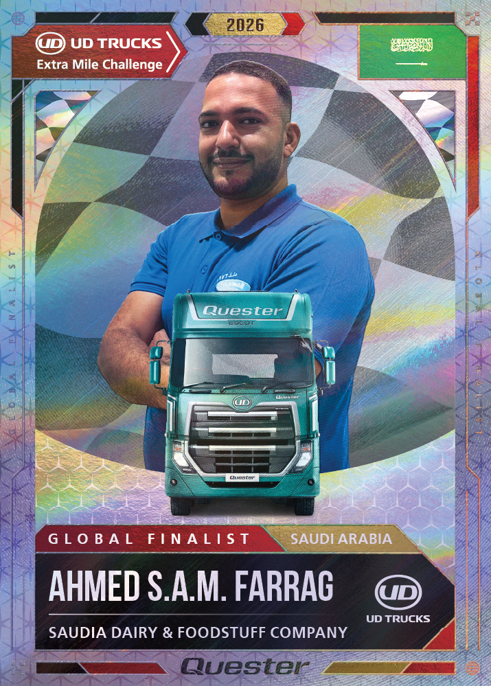 Smiling man in blue shirt standing behind a green UD truck graphic, finalist card design.