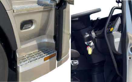 Truck step and interior with steering wheel and key in ignition.