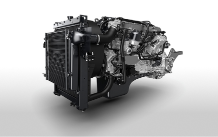 Modern automotive engine with visible radiator and metallic components on white background.