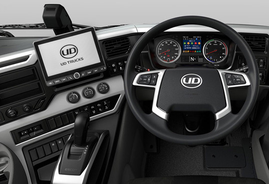 Modern truck dashboard with digital displays, steering wheel, and controls in black and silver.